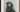 Black and white portrait of a person in large dark hood inspired by louise bourgeois and marina abramović rituals