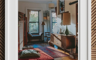 Cozy eclectic living room with vintage furniture and colorful rugs showcasing mixed patterns from early 20th centuries