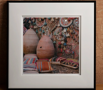Terracotta egg-shaped pot with small hole near top showcasing handcrafted decorations and personal touch through human intervention