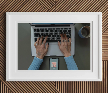 Laptop with hands typing on keyboard illustrating the creative process of australian theatre in not in print article