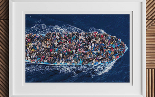Overcrowded boat with asylum seekers wearing colorful clothing illustrating staging asylum and digital extension themes