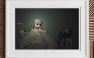 Vintage porcelain doll in white dress with golden accents showcasing classic play brought to life offstage by australia council