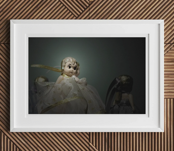 Vintage porcelain doll in white dress with golden accents showcasing classic play brought to life offstage by australia council