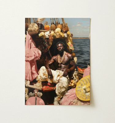 A framed photographic print of a black gay man in cream attire with gold chains seated on a decorated boat in black gay wall art