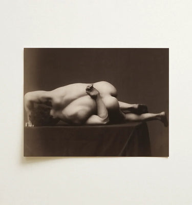 Sepia-toned photographic print of two nude figures in an intimate pose from the black and white nudes collection