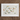 Framed artwork featuring colorful embroidered butterflies on a light background.