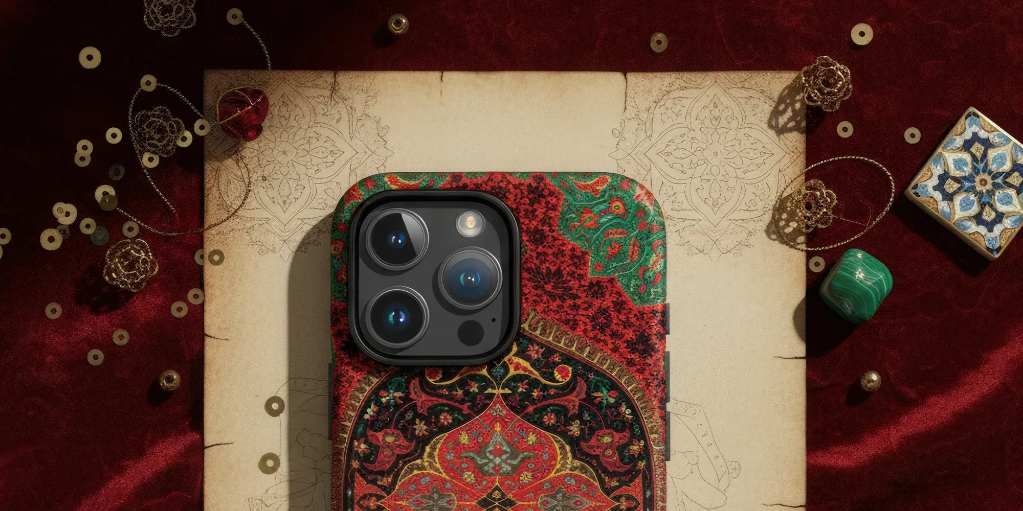 Ornate floral-patterned phone case held in a hand.