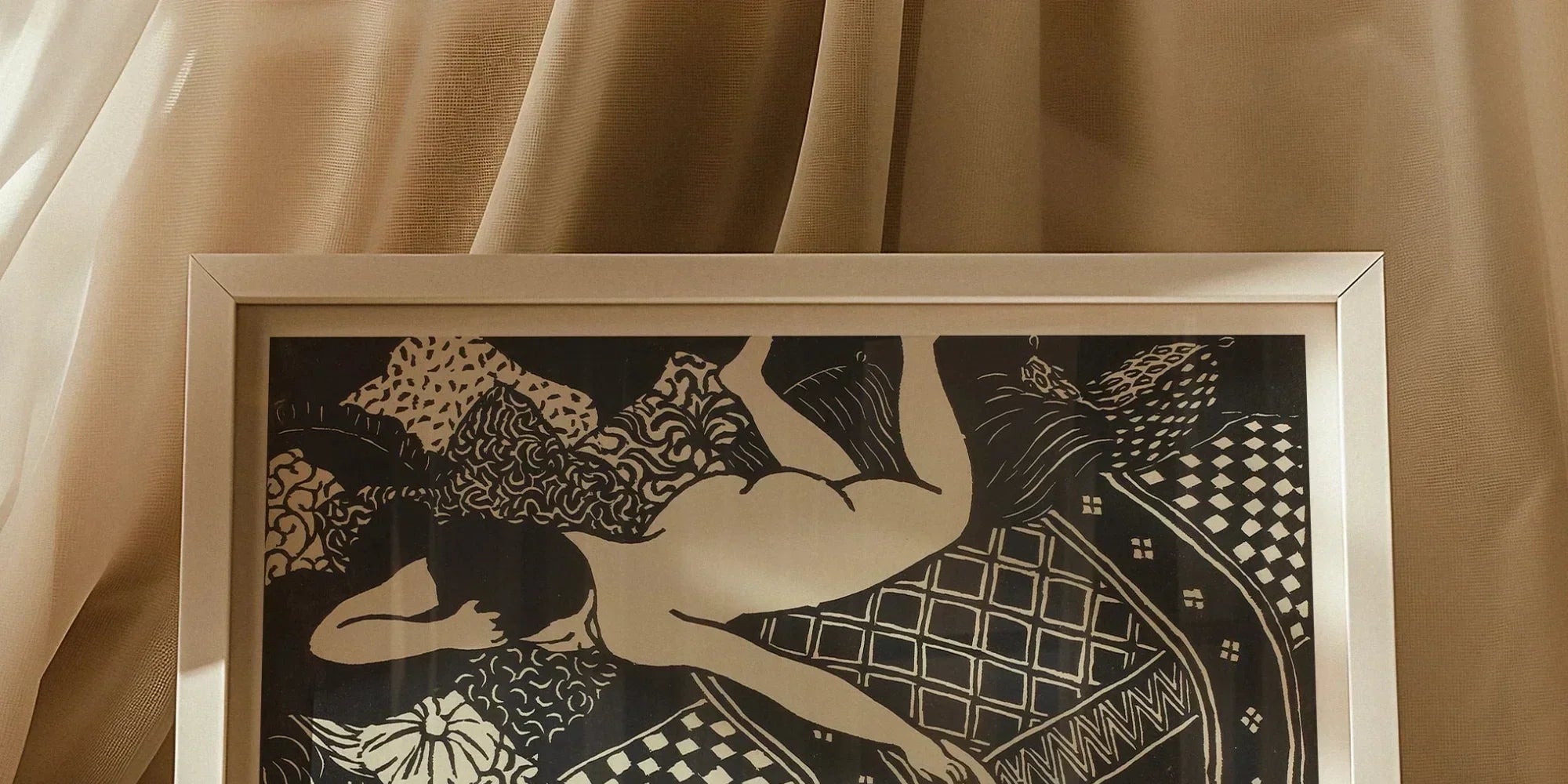 Framed black and white artwork depicting a figure floating among decorative geometric patterns and designs.
