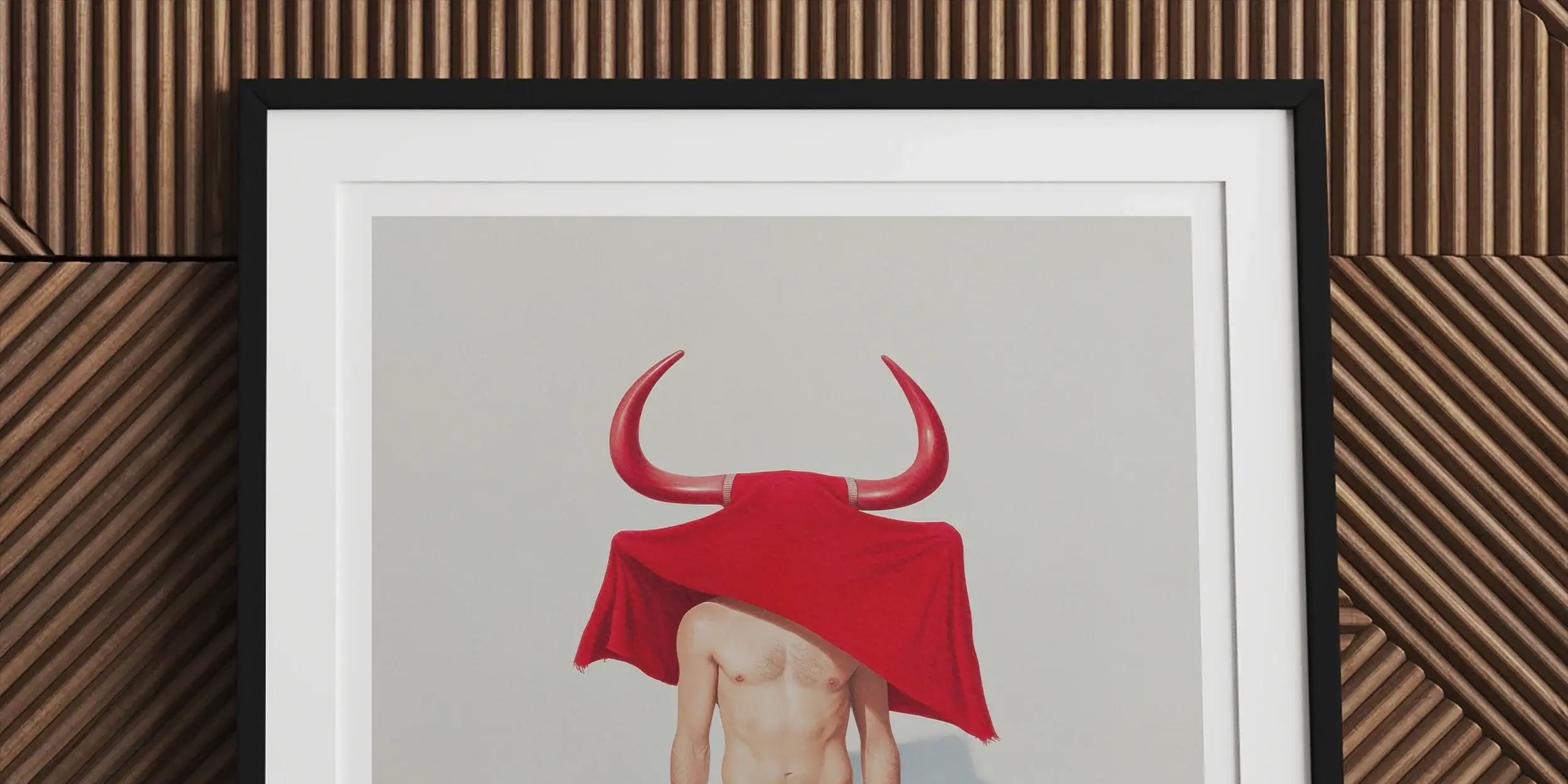 Framed artwork depicting a figure wearing white underwear and a red bull-horned headdress covering their head.