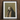 Framed artwork depicting a ethereal figure standing on a crescent moon, scattering stars.