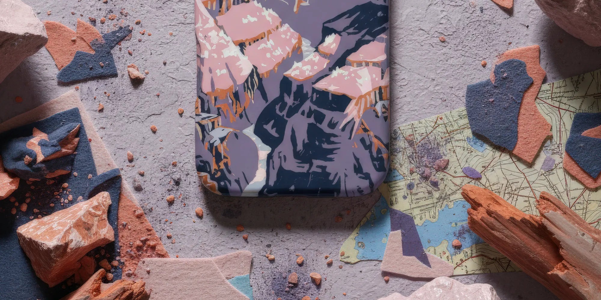 IPhone with an ornate case featuring ancient jewelry and coin designs in gold and turquoise colors.