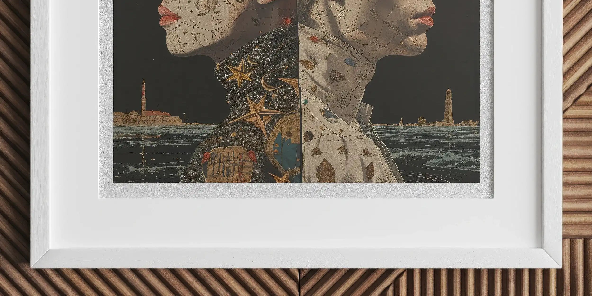 Framed artwork depicting two profile faces with celestial and nautical imagery.