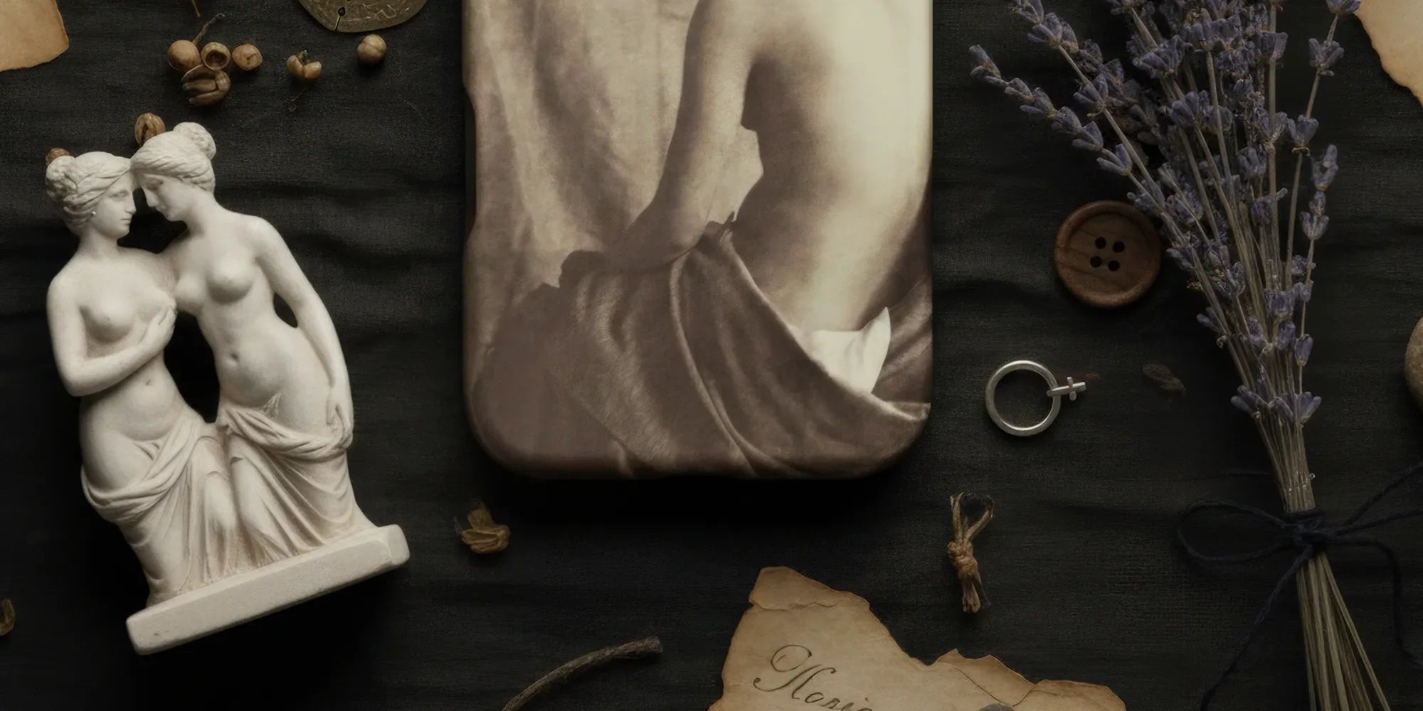 IPhone with a sepia-toned nude figure case.
