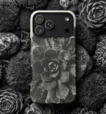 Natural history phone cases featuring a black and white floral design surrounded by organic materials.