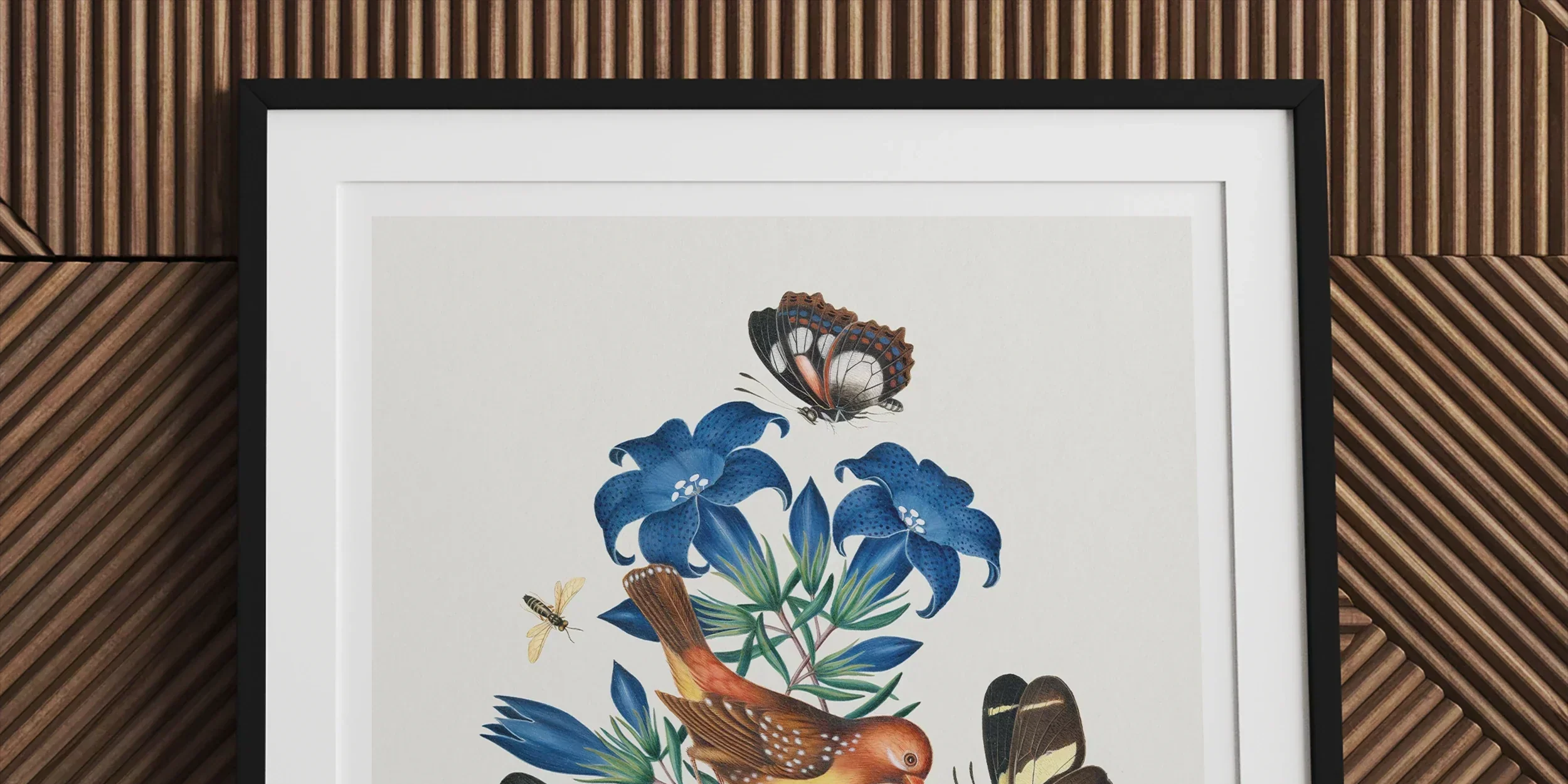 Framed botanical illustration featuring blue flowers, birds, and butterflies.