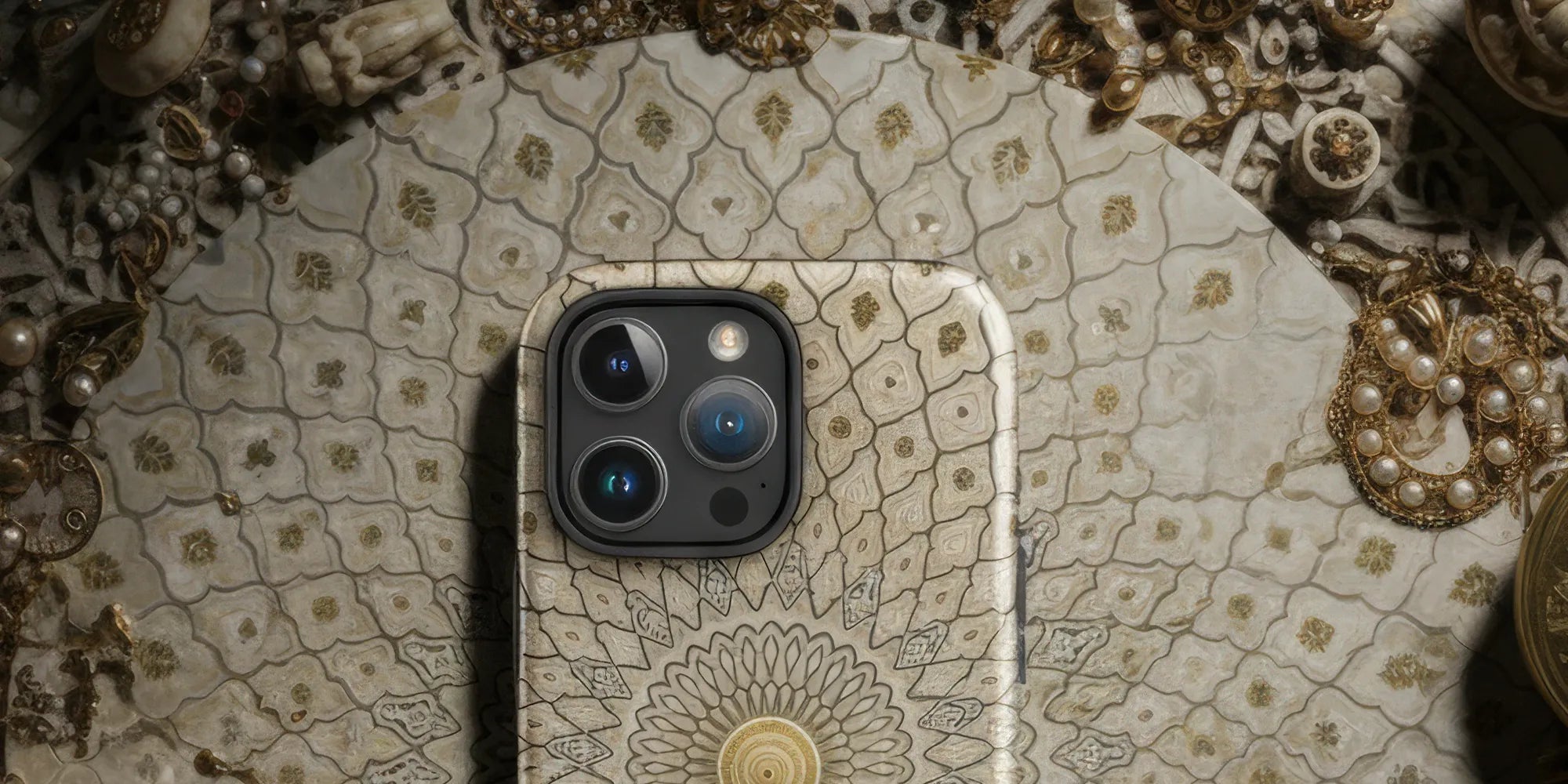 Smartphone with a decorative mandala-patterned case.