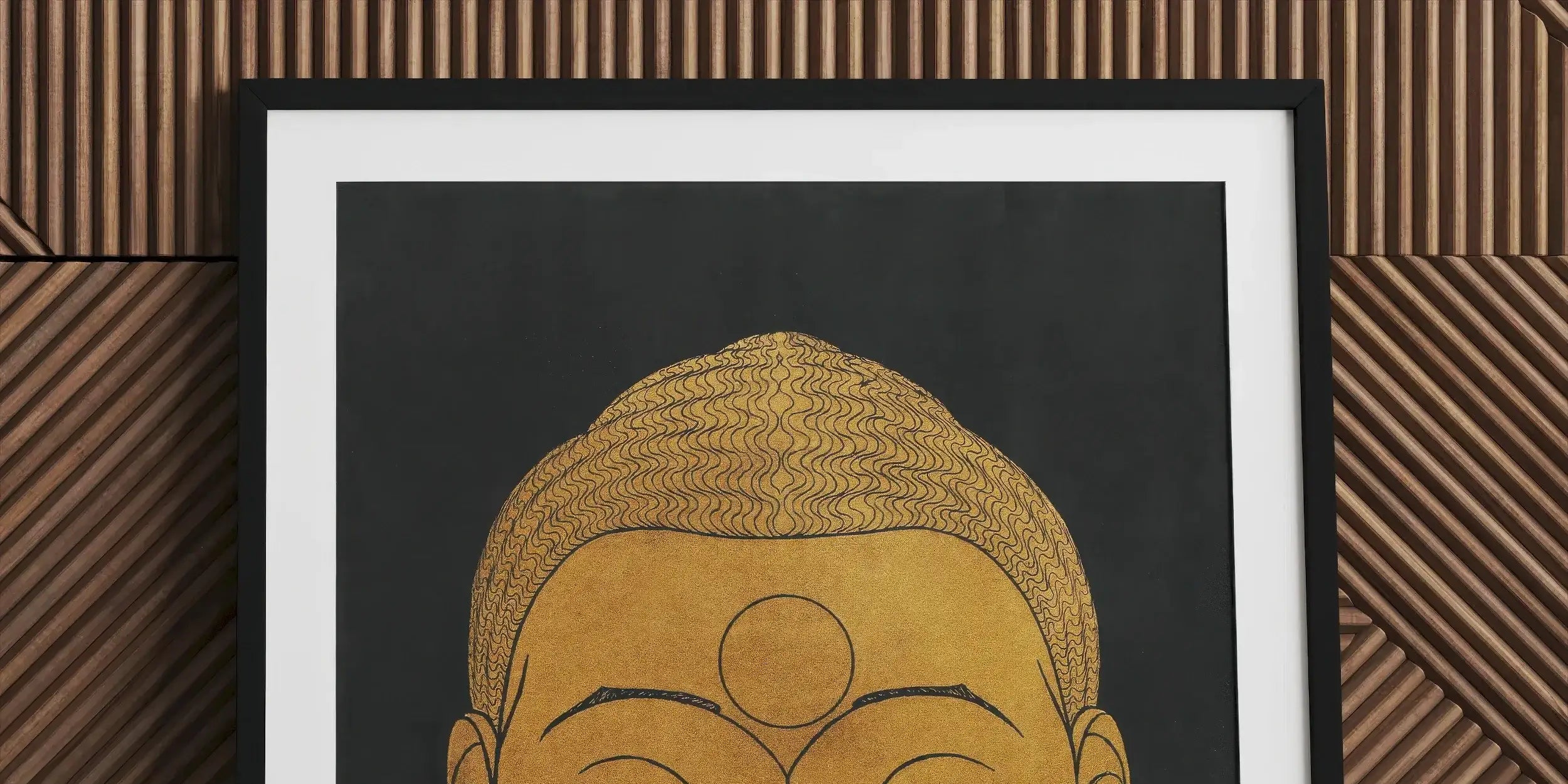 Golden stylized Buddha head with closed eyes and serene expression.