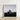 Black-and-white Framed Photograph Stone Tree Brick House with Muted Silver, Blank Sky Cloud Cover, Light Seeps Through