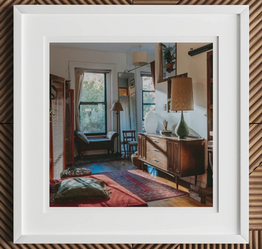 Cozy eclectic living room with vintage furniture and colorful rugs showcasing mixed patterns from early 20th centuries