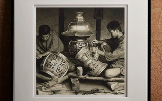 Artisans crafting ornate metal lanterns highlighting traditional japanese craftsmanship and meticulous attention to detail