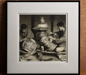 Artisans crafting ornate metal lanterns highlighting traditional japanese craftsmanship and meticulous attention to detail