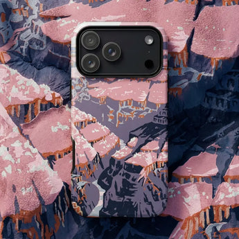 American Art Phone Cases showcasing a vibrant landscape with clouds and earth tones, surrounded by eclectic decorative objects.