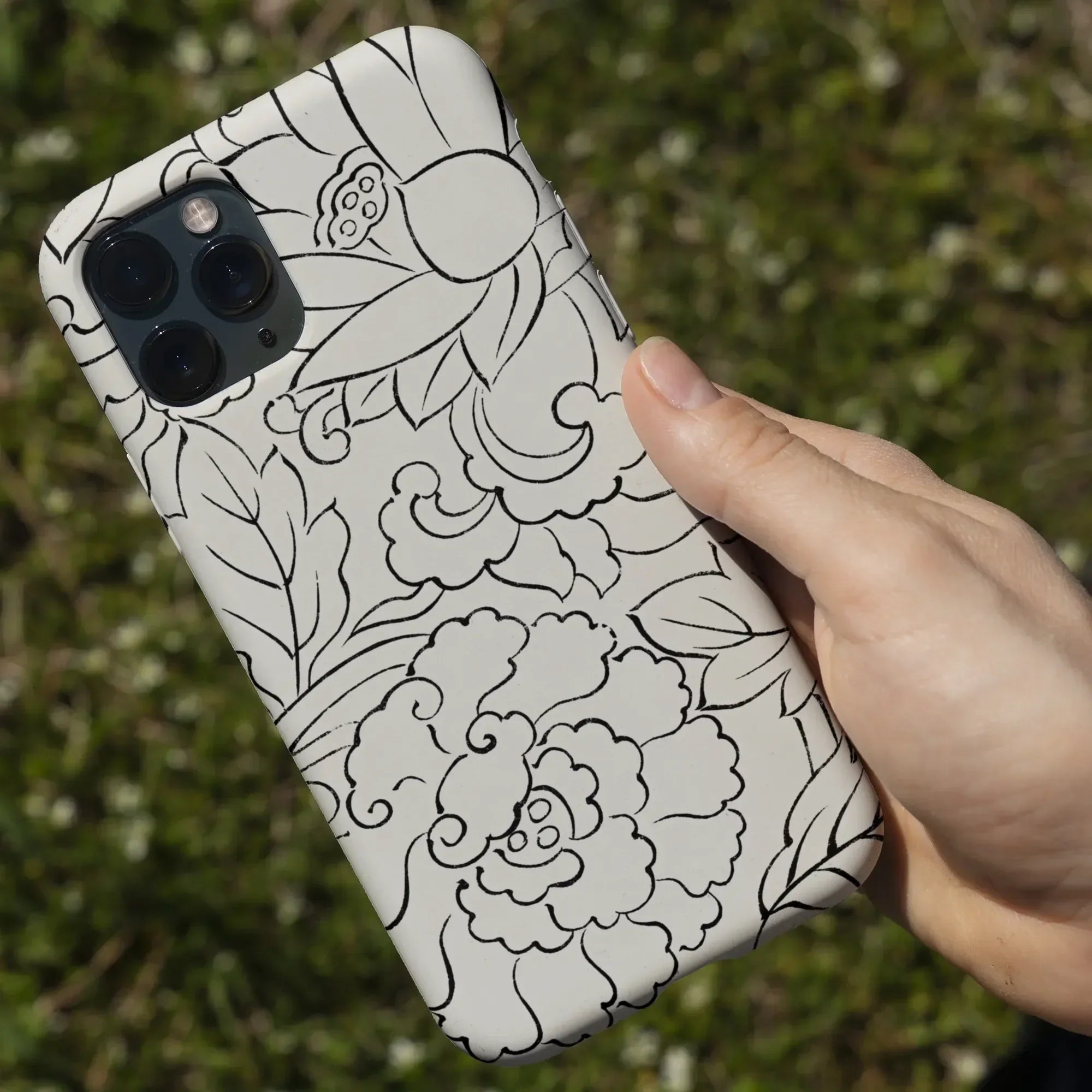 IPhone with a decorative floral pattern case.