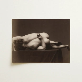 Sepia-toned photographic print of two nude figures in an intimate pose from the black and white nudes collection
