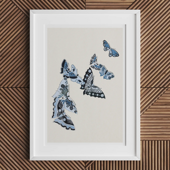 Framed artwork depicting blue and white butterflies in flight.