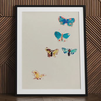 Framed artwork featuring colorful embroidered butterflies on a light background.
