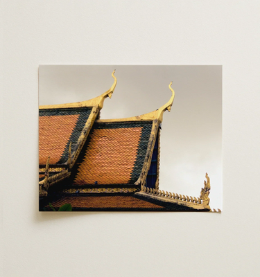 Cambodian Wall Art: Close-up of a traditional temple roof with intricate details, showcasing the elegance of Cambodian architecture.