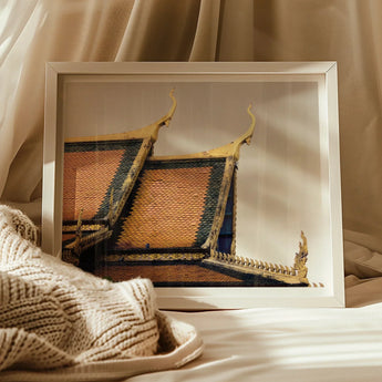 Framed photograph of ornate Thai temple roofs with golden spires.