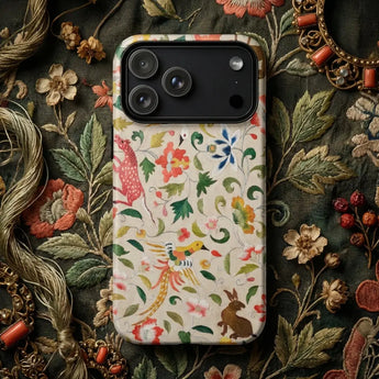 Colorful decorative phone cases set on a rich, patterned fabric background showcasing folk art elements.