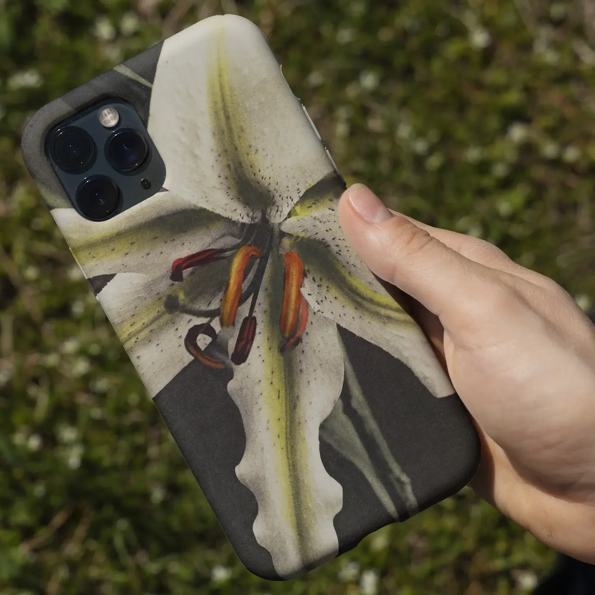 IPhone case featuring a close-up photograph of a white lily flower.