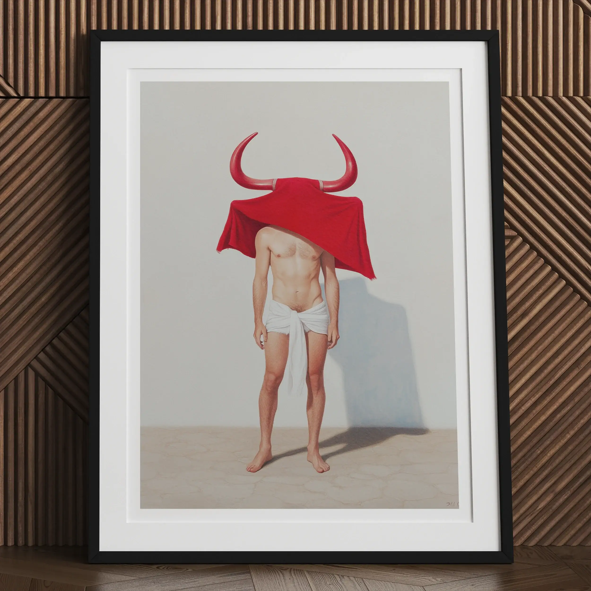 Framed artwork depicting a figure wearing white underwear and a red bull-horned headdress covering their head.