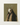 Framed artwork depicting a ethereal figure standing on a crescent moon, scattering stars.