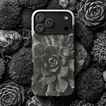 Natural history phone cases featuring a black and white floral design surrounded by organic materials.