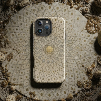 Smartphone with a decorative mandala-patterned case.