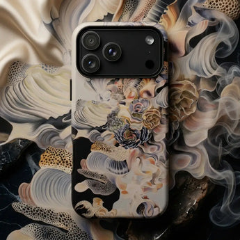 Surreal Phone Cases featuring a detailed artistic design on a mobile device surrounded by shells and succulents.