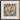Framed ornate floral tapestry or rug with intricate patterns in rich colors on a dark background.