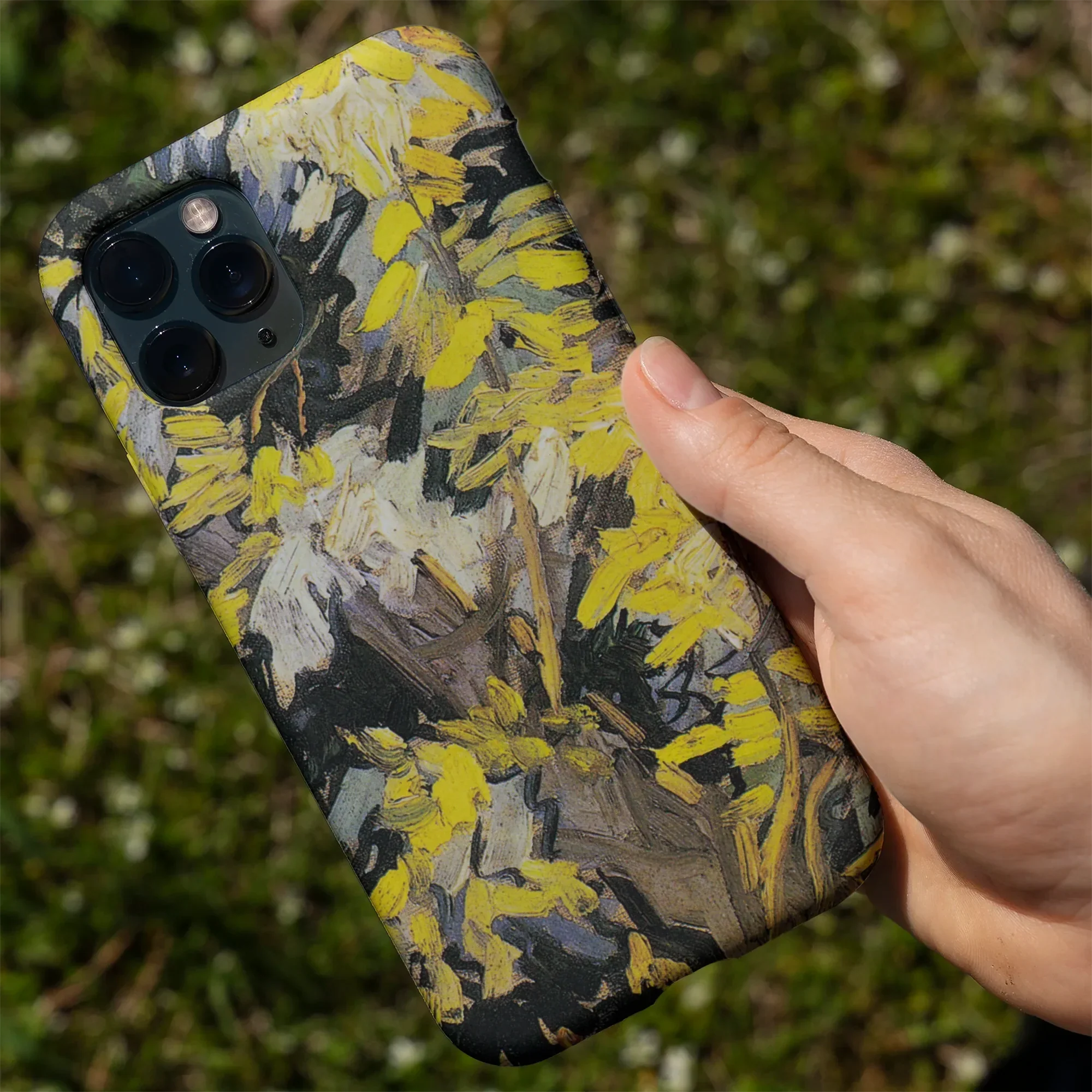 IPhone case featuring a design of vibrant yellow chrysanthemums.