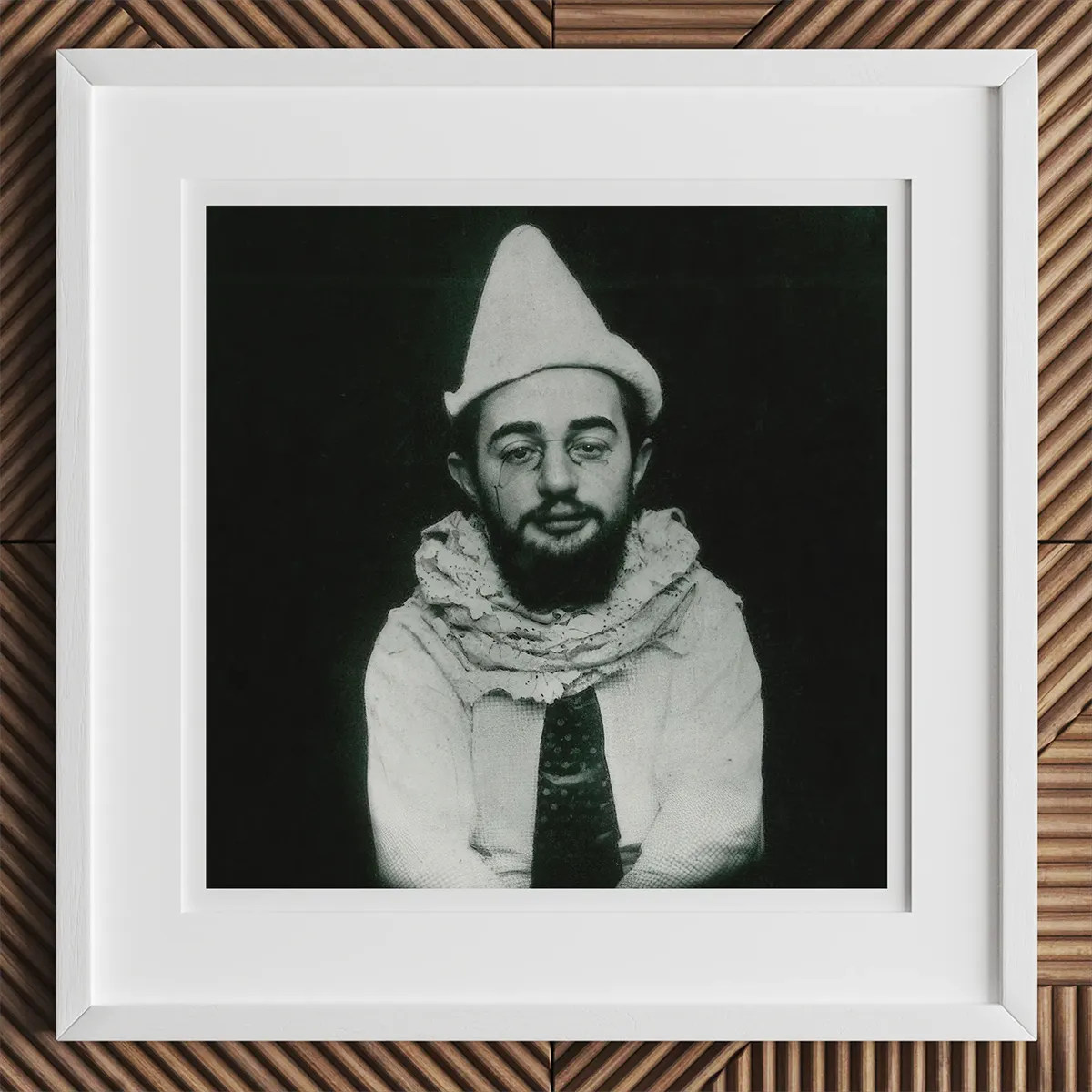 Black and white portrait of a man in a conical hat and scarf, inspired by Andy Warhol artistry