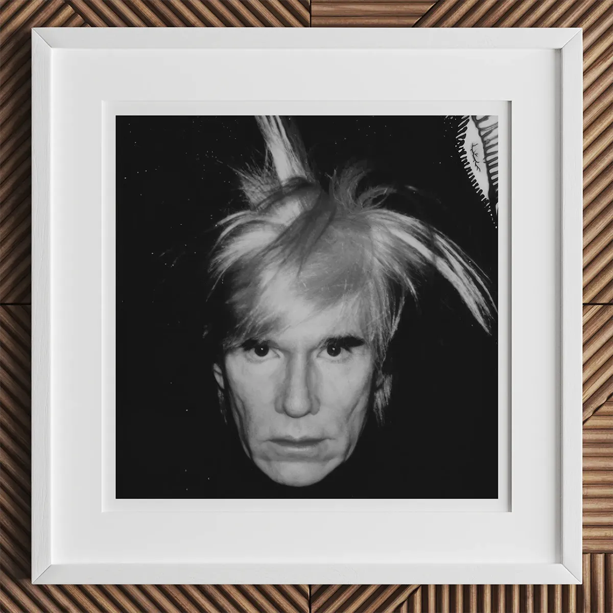 Framed black and white portrait of Andy Warhol featured in 14 Artists Habits article