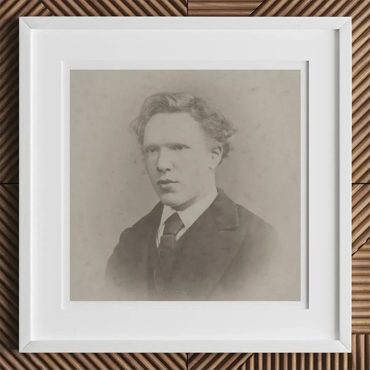 Framed black and white portrait of a young man with wavy hair in suit and tie, inspired by Andy Warhol or Chuck Close