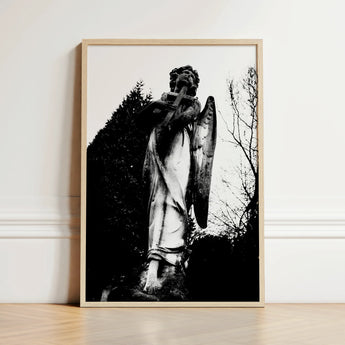 Black-and-white Framed Photograph Weathered Stone Angel Statue Cross Figure Carved