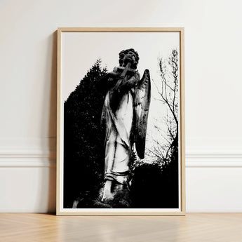 Black-and-white Framed Photograph Weathered Stone Angel Statue Cross Figure Carved