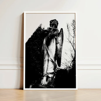 Black-and-white Framed Photograph Weathered Stone Angel Statue Cross Figure Carved