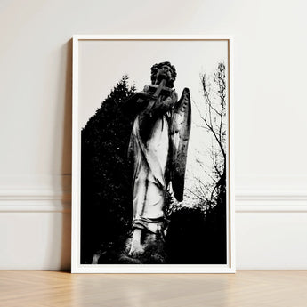 Black-and-white Framed Photograph Weathered Stone Angel Statue Cross Figure Carved
