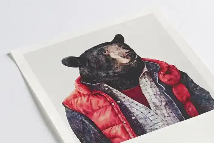 Artistic portrait of a black bear wearing a red puffy vest and plaid shirt.