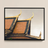 Black-framed Photograph Traditional Thai Temple Roof Ornate Golden Cambodian Photography, Temple’s Embodies Timeless Grandeur, Brooding Sky